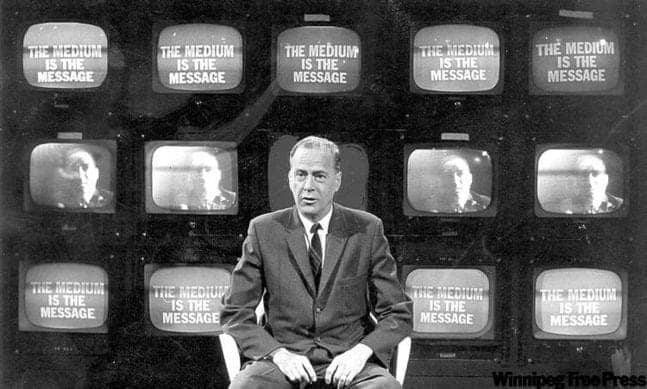 Man sitting in front of multiple screens