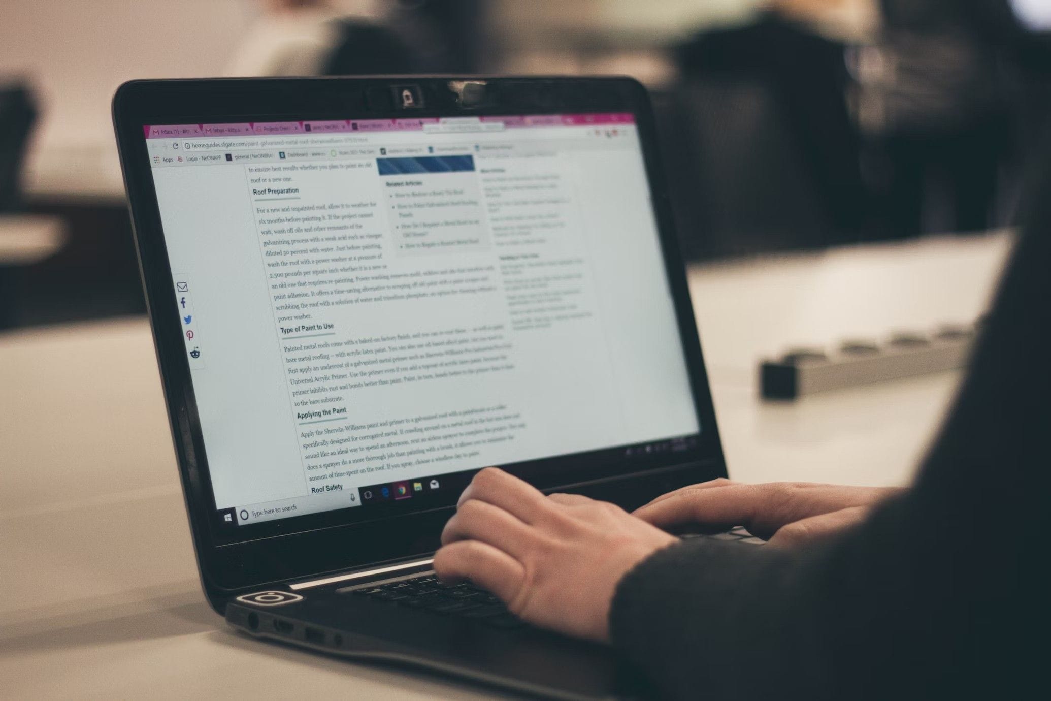 Person writing content on a laptop for LinkedIn ghostwriting or professional content creation