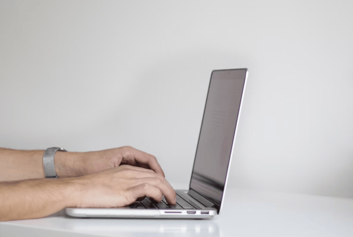 Professional writing a LinkedIn bio on a laptop