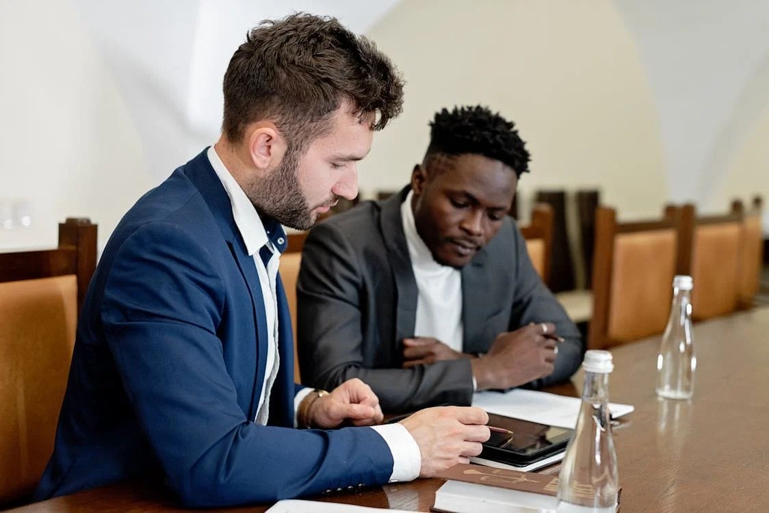 professionals collaborating while writing an executive bio