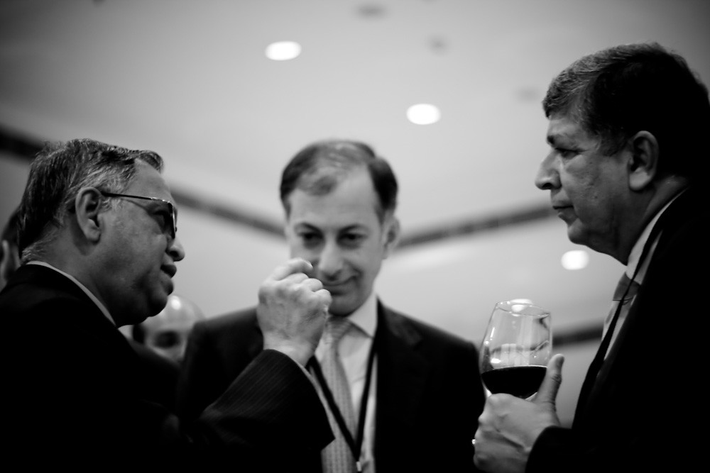 Business leaders in discussion at a networking event, representing AI-driven thought leadership and executive insights
